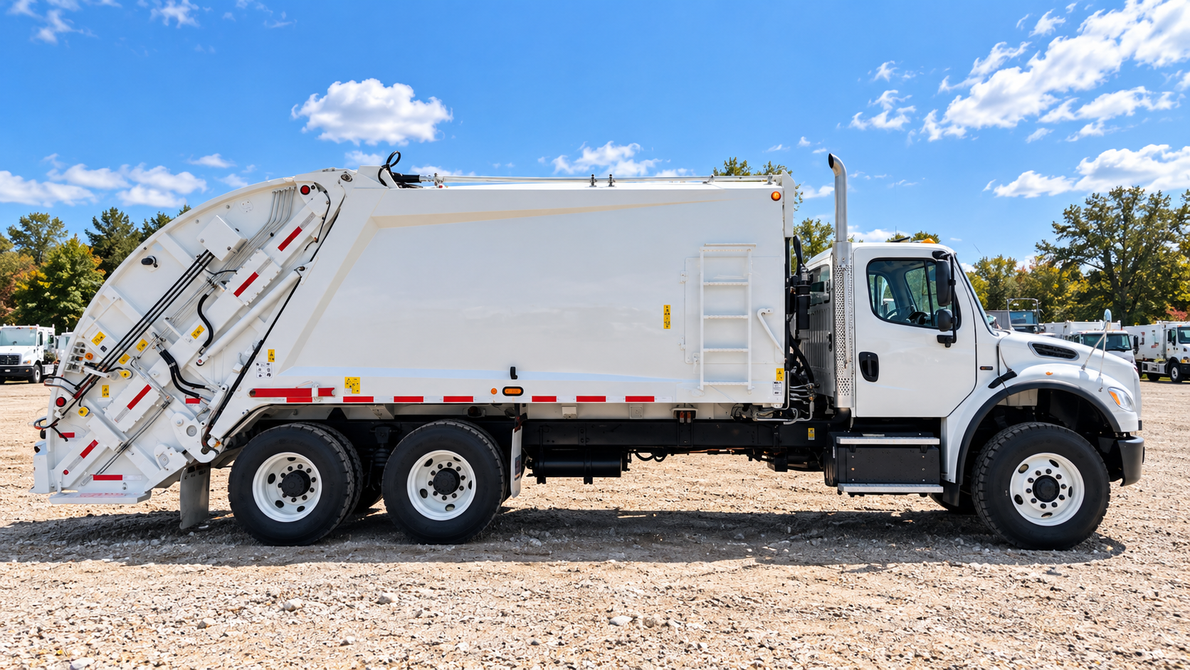 Rear loader truck in gravel lot