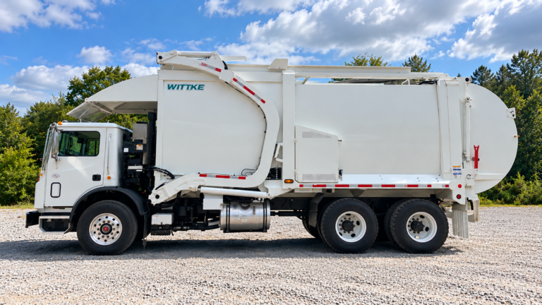 Front Loader garbage truck on gravel lot